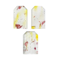 Three stacks of Pink and Yellow Plantable Seed Paper Blank Gift Tags by Seed Bloom Gifts are arranged on a white background, highlighting the distinct color streaks and floral inclusions.