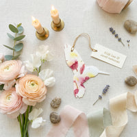 Hummingbird-themed wedding decoration featuring plantable seed paper for a unique and eco-friendly touch