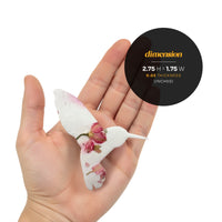 A person holds a small bird with a flower, highlighting the Hummingbird Memorial Plantable Seed Pape