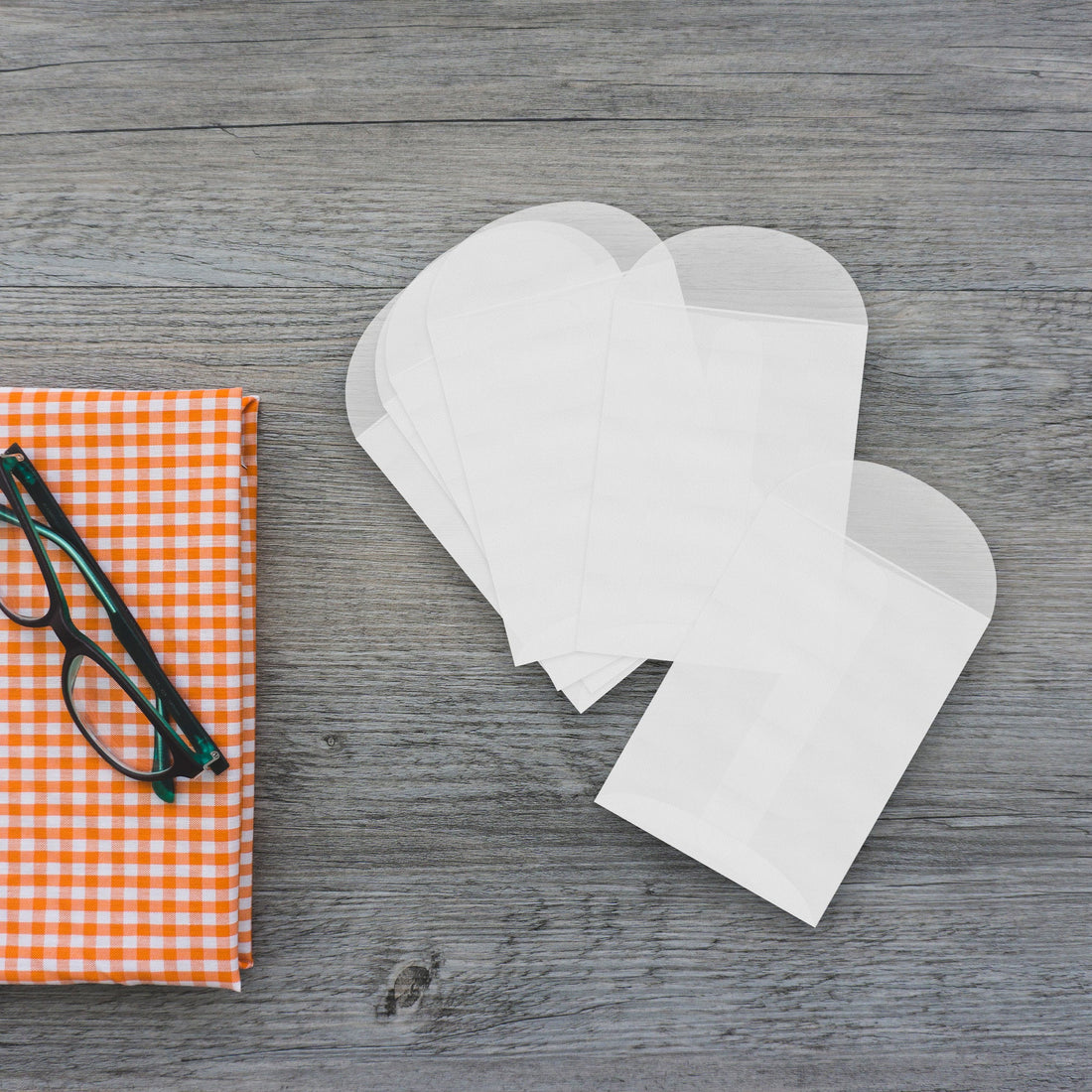 Stack of glassine paper envelopes used for Seed Bloom Gifts eco-friendly seed paper packaging