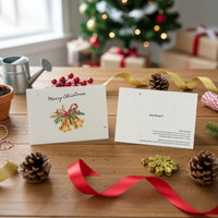 Plantable Holiday Christmas cards by Seed Bloom Gifts with decorative elements on a wooden table with a festive background.
