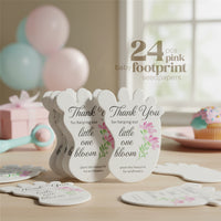 24 pcs pink Baby footprint seed paper baby shower favor by Seed Bloom Gifts with floral designs and text on a wooden surface.