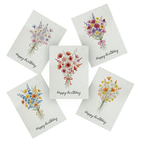 A set of four birthday cards adorned with flowers, each displaying "Happy Birthday" in cheerful lettering