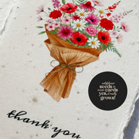 A thank you card featuring a colorful bouquet of flowers, labeled "Bloom Thank You Cards.