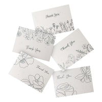 A set of Bloom thank you cards adorned with floral designs and the phrase "Thank You" prominently displayed