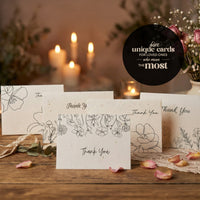 A collection of popular wedding thank you cards featuring unique floral designs and elegant typography