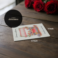 Mother's Day Bloom Card product dimension: Greeting card with flower shop illustration displayed on wooden surface next to red roses, showing card measurements of 4.75 inches by 3.5 inches