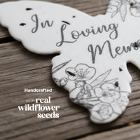Decorative plantable memorial favor by Seed Bloom Gifts with 'In Loving Memory' text on a wooden surface, featuring handcrafted design and real wildflower seeds.