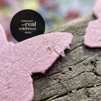 Pink butterfly Confetti Seed Paper embedded with real wildflower seeds on wood