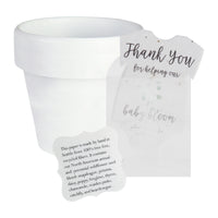 White pot next to a gender neutral green onesie plantable seed paper baby shower favor by Seed Bloom gifts, with a small card detailing the wildflower seed blend.