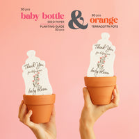 Seed paper baby bottle baby shower favor and terracotta pots with planting guide on a pink background
