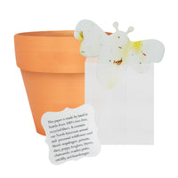Terracotta pot with a white card featuring
Bee Shaped Seed Paper Baby Shower Favor By Seed Bloom Gifts and a pressed flower on a white background