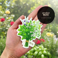 Hand holding a sticker of a bouquet of herbs with a product size label in the corner.