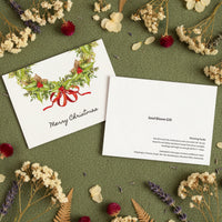 Seed bloom gift card with Christmas design on a green background with flowers