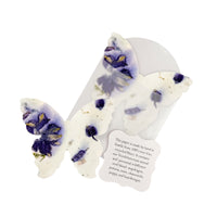 Celebration of life butterfly-shaped seed paper with purple flowers on a white background