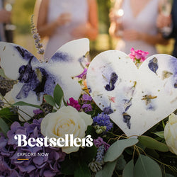 Bestselling heart-shaped plantable seed paper favors with embedded wildflower petals, displayed on a planting instruction card by Seed Bloom Gifts