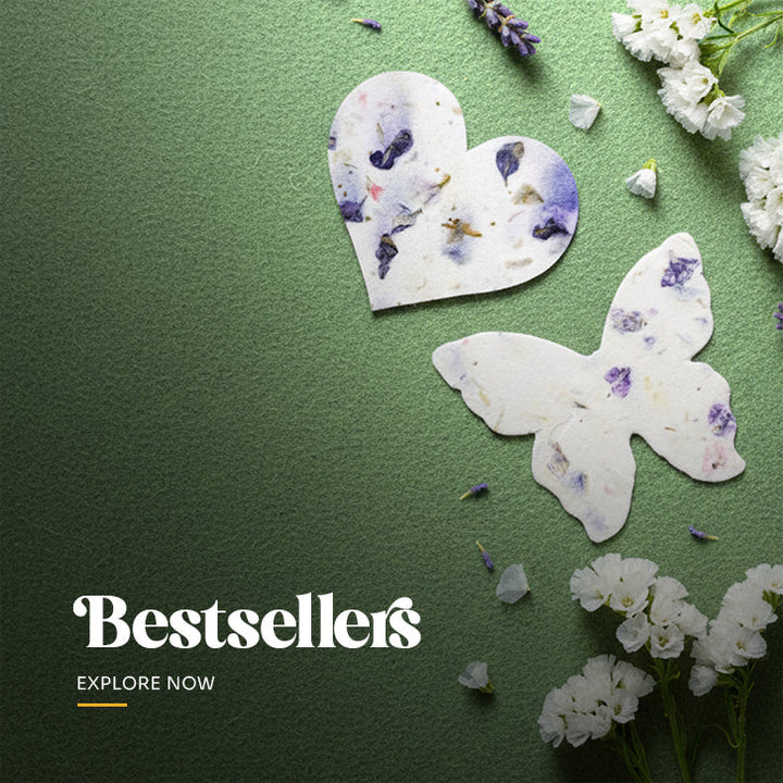 Bestselling heart-shaped plantable seed paper favors with embedded wildflower petals, displayed on a planting instruction card by Seed Bloom Gifts