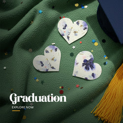 Heart-shaped plantable seed paper favors with embedded wildflower petals, presented on a white planting instruction card, often used as graduation party favors by Seed Bloom Gifts