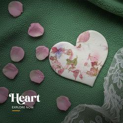 Plantable seed paper heart shape favor cut into the shape of a seated cat angel, embedded with visible blue and purple petals by Seed Bloom Gifts