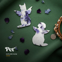 Plantable seed paper pet memorial favor cut into the shape of a seated cat angel, embedded with visible blue and purple petals by Seed Bloom Gifts