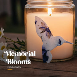 Plantable seed paper pet memorial favor cut into the shape of a seated cat with angel wings, embedded with visible pink and green wildflower petals by Seed Bloom Gifts