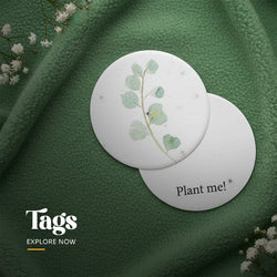 Single plantable seed paper gift tag with a hole-punched top corner, featuring large embedded pink dried wildflower petals and showing the textured surface by Seed Bloom Gifts