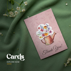 Set of four plantable Thank You cards featuring a watering can and colorful wildflower bouquet design in assorted colors, packaged with brown kraft envelopes by Seed Bloom Gifts.