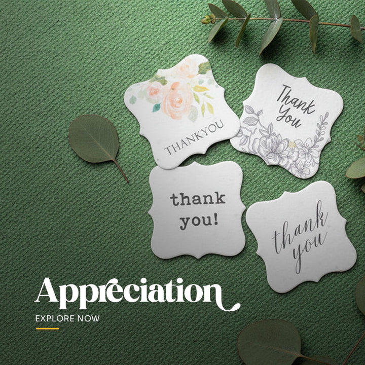 Plantable seed paper appreciation tag in a decorative die-cut shape, printed with 'Thank You' text and a detailed gray ink floral and vine design by Seed Bloom Gifts