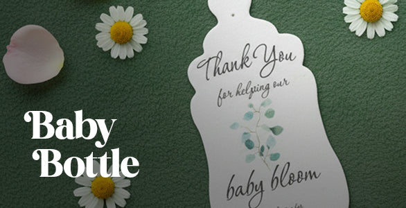Baby bottle-shaped seed paper card with 'Thank You' message on a green background with flowers