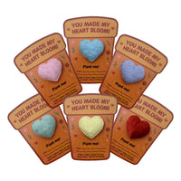 Assorted multicolor plantable 3D heart seed paper gifts displayed on illustrated “You Made My Heart Bloom” cards by Seed Bloom Gifts