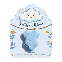 Blue onesie seed pop favor with happy cloud design and "Baby in Bloom" text, includes planting instructions