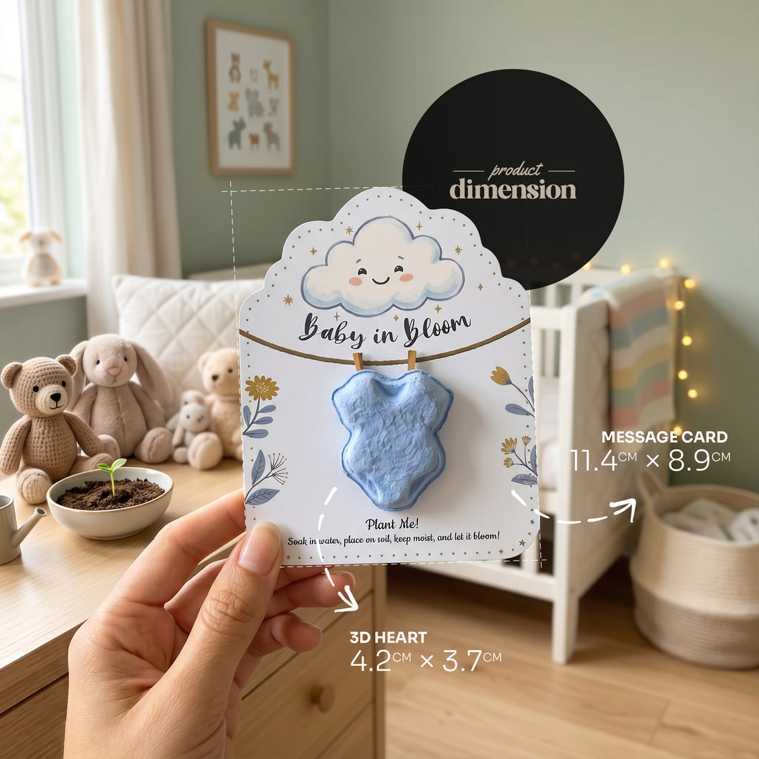 Baby in Bloom baby boy onesie seed paper product dimensions - light blue 3D heart 4.2cm x 3.7cm, message card 11.4" x 8.9cm, held in hand in nursery setting with toys and plants