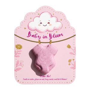 Pink onesie seed pop favor with happy cloud design and "Baby in Bloom" text, includes planting instructions