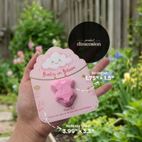 Baby in Bloom onesie seed paper product dimensions - 3D onesie 1.75" x 1.5", message card 3.99" x 3.3", held in hand in garden setting