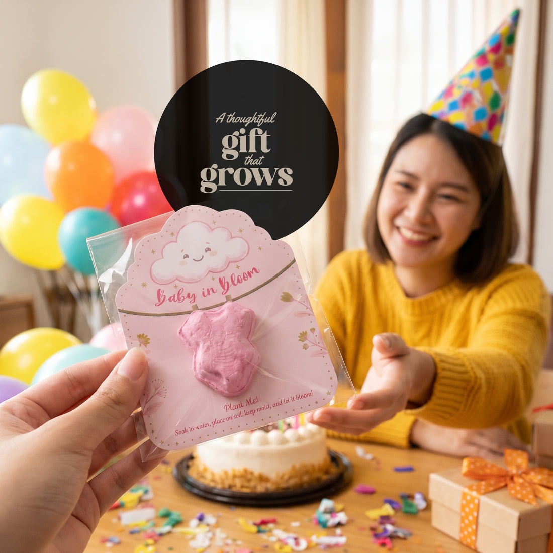 Baby in Bloom onesie seed paper favor - "a thoughtful gift that grows" message card being gifted at colorful celebration party with balloons and cake
