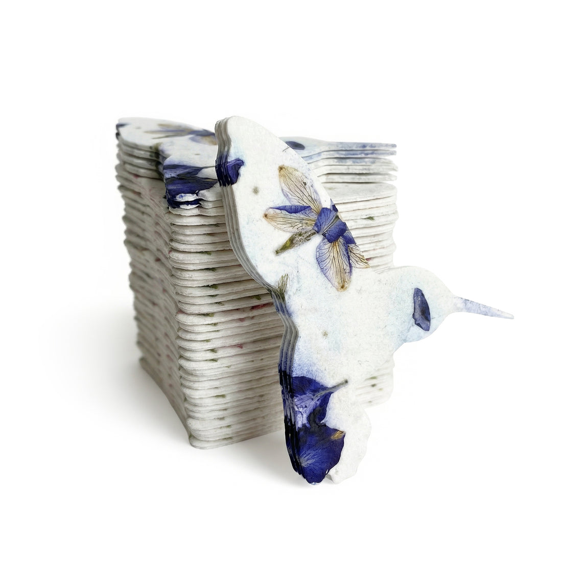 A collection of blue and white ceramic birds, including a hummingbird, designed for memorial plantable seed paper