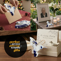 A person presents a card alongside a butterfly photo, highlighting Hummingbird Memorial Plantable Seed Paper