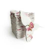 A stack of folded paper featuring pink flowers, labeled as Hummingbird Memorial Plantable Seed Paper