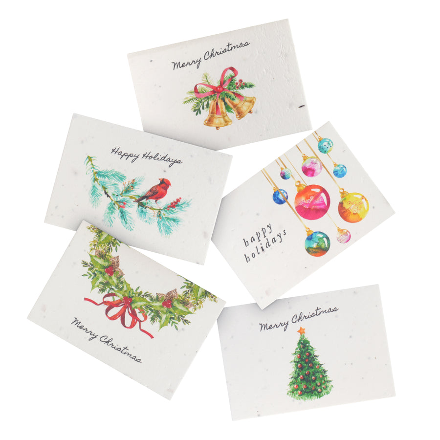 Close-up of a set of plantable holiday greeting cards by Seed Bloom Gifts, emphasizing the seed paper texture. A sustainable Christmas Holiday Gift that grows into wildflowers.