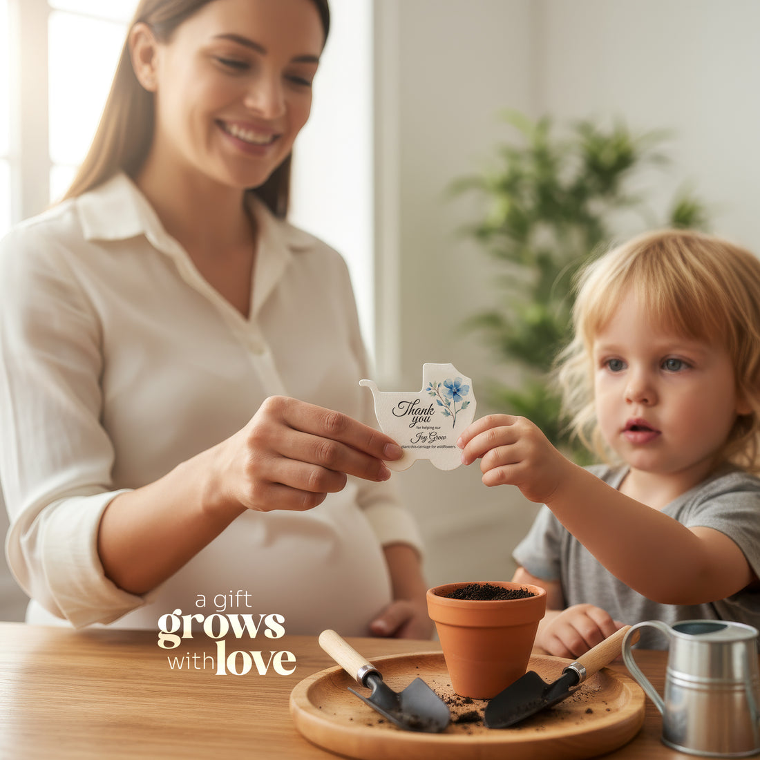 Woman and child with a potted plant holding a seed paper shaped in baby carriage by Seed Bloom gifts and gardening tools, featuring &