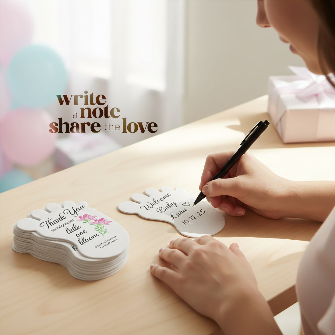 Person writing on A Baby footprint seed paper baby shower favor by Seed Bloom Gifts with &