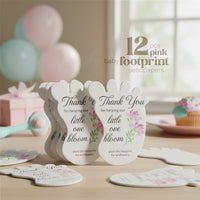 12 Baby footprint seed paper baby shower favor by Seed Bloom Gifts seedpapers with floral designs and text on a wooden surface.
