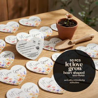 Heart-shaped seed paper packets with printed planting instructions on a wooden table by Seed Bloom Gifts