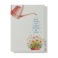A vibrant greeting card for Mother's Day with blooming flowers and the phrase "Mom always makes me grow" prominently displayed