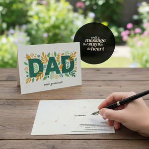  Father's Day card featuring a floral design, a pen, and a handwritten note beside it