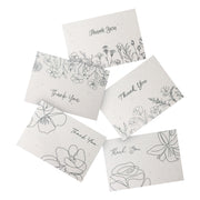  A set of Bloom thank you cards adorned with floral designs and the phrase "Thank You" prominently displayed