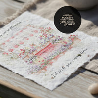Mother's Day Bloom Card: Greeting card with flower shop illustration and text 'If moms were flowers, I'd pick you every time' displayed on wooden surface with cream fabric, featuring a quote bubble reading 'wildflower seeds in every card, yes, really grows!