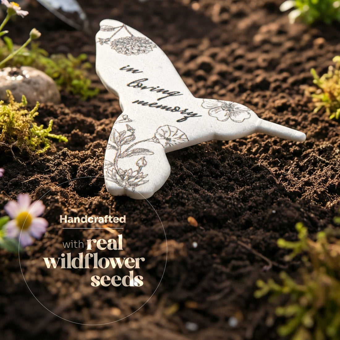 White dove-shaped seed packet with floral designs and text on a soil background by Seed Bloom Gifts