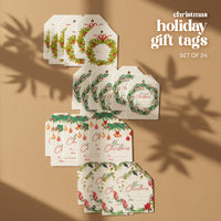 Overhead flat lay of four distinct stacks of Christmas Holiday Gift tags  by Seed Bloom Gifts. Arranged on a neutral brown background with subtle shadows. The tags feature wreath, ornament, and mistletoe designs.