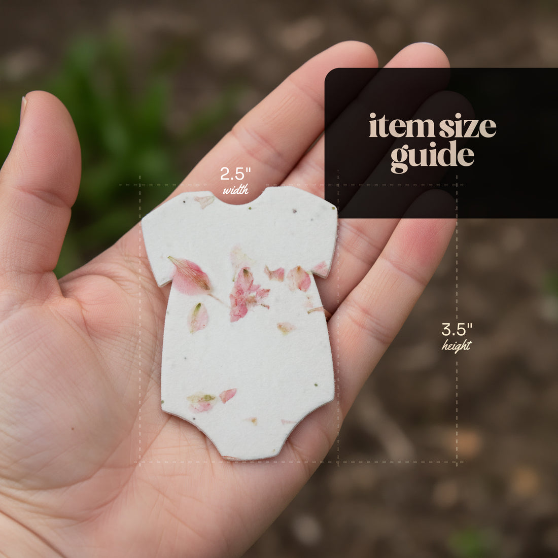 Bloom Plantable Seed Paper Baby Shower Kit onesie size guide showing 2.5 inches wide by 3.5 inches tall with pressed pink flowers